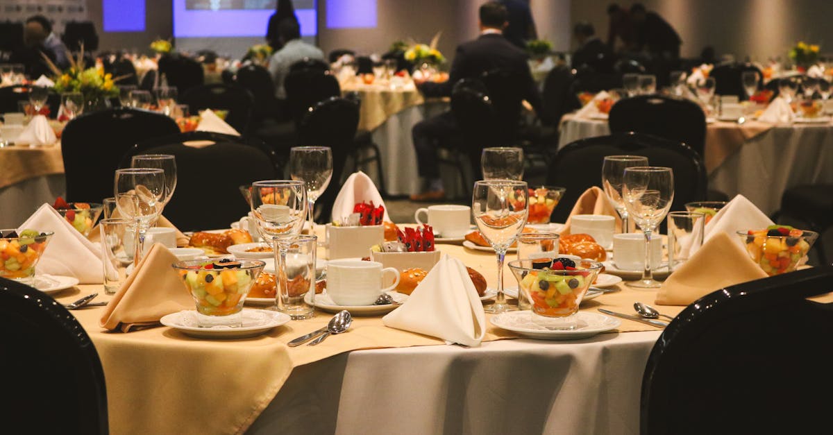 A beautifully arranged dining table set for an elegant banquet or event inside a restaurant.